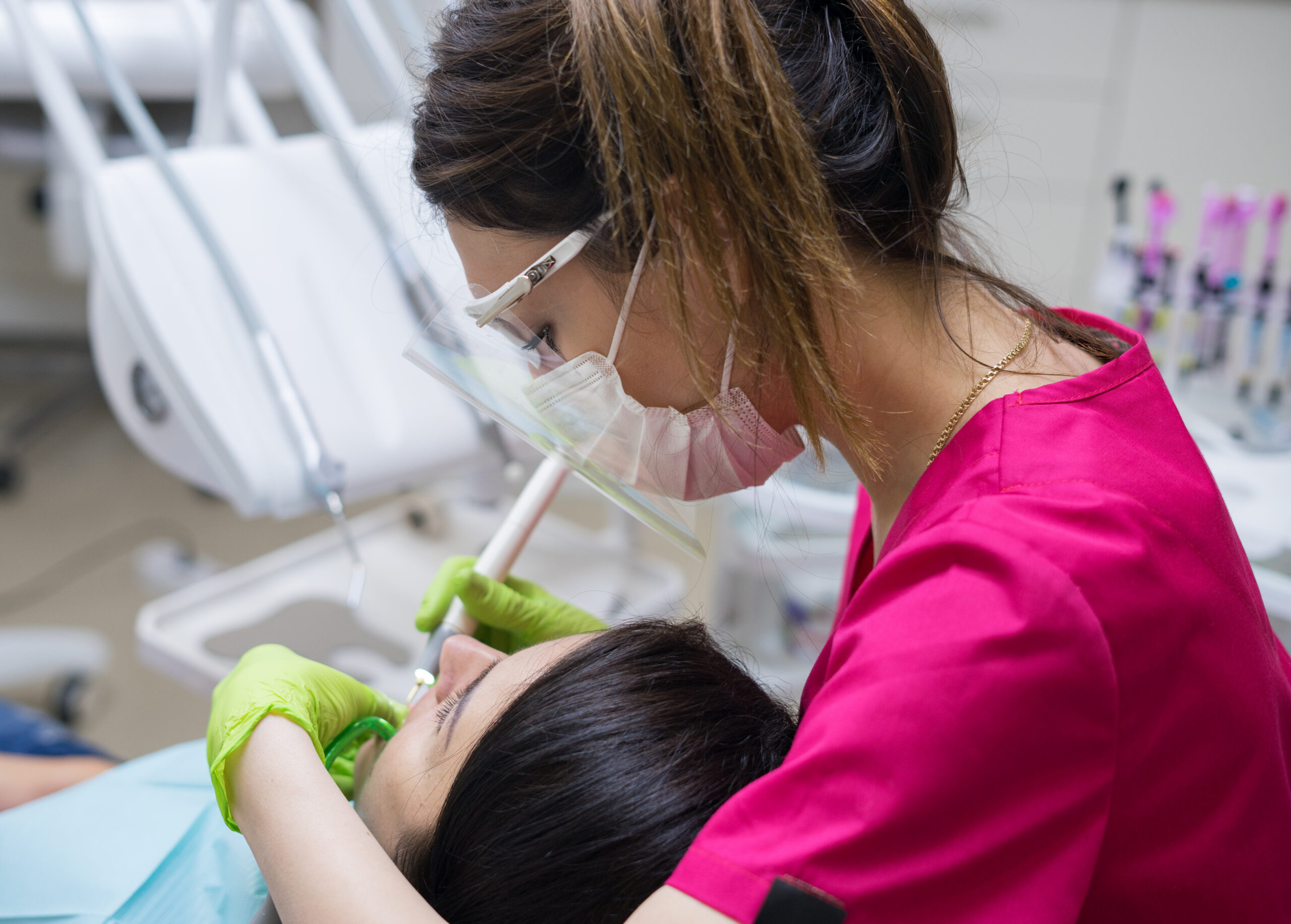 dentist cleaning teeth of woman